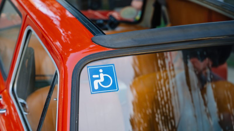 Russia, Rostov-on-Don, 14.10.2023. disabled badge. Vintage old red Moskvich car. Soviet automobile industry. Exhibition of vintage cars.